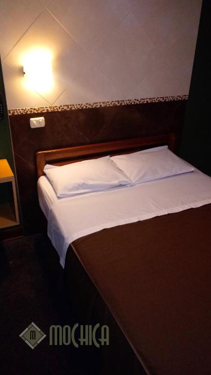 Postel nebo postele na pokoji v ubytování Hostal Residencial Mochica