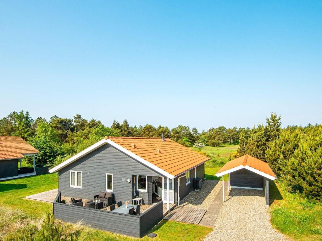a small house with a roof on a field at 8 person holiday home in Ulfborg in Fjand Gårde