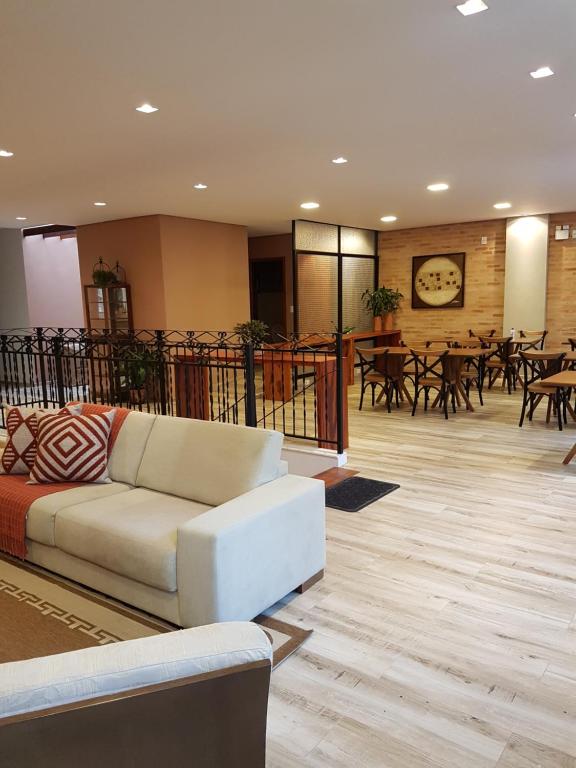 a living room with a couch and tables and chairs at Vila de Cunha in Cunha