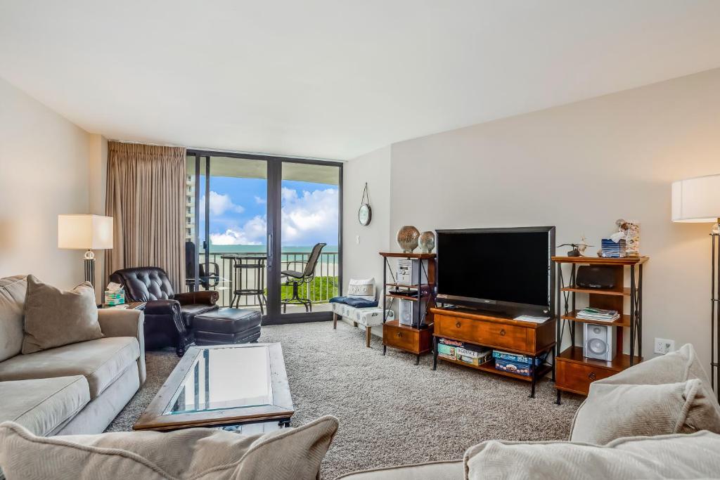 a living room with a couch and a television at South Seas Sunsations in Marco Island