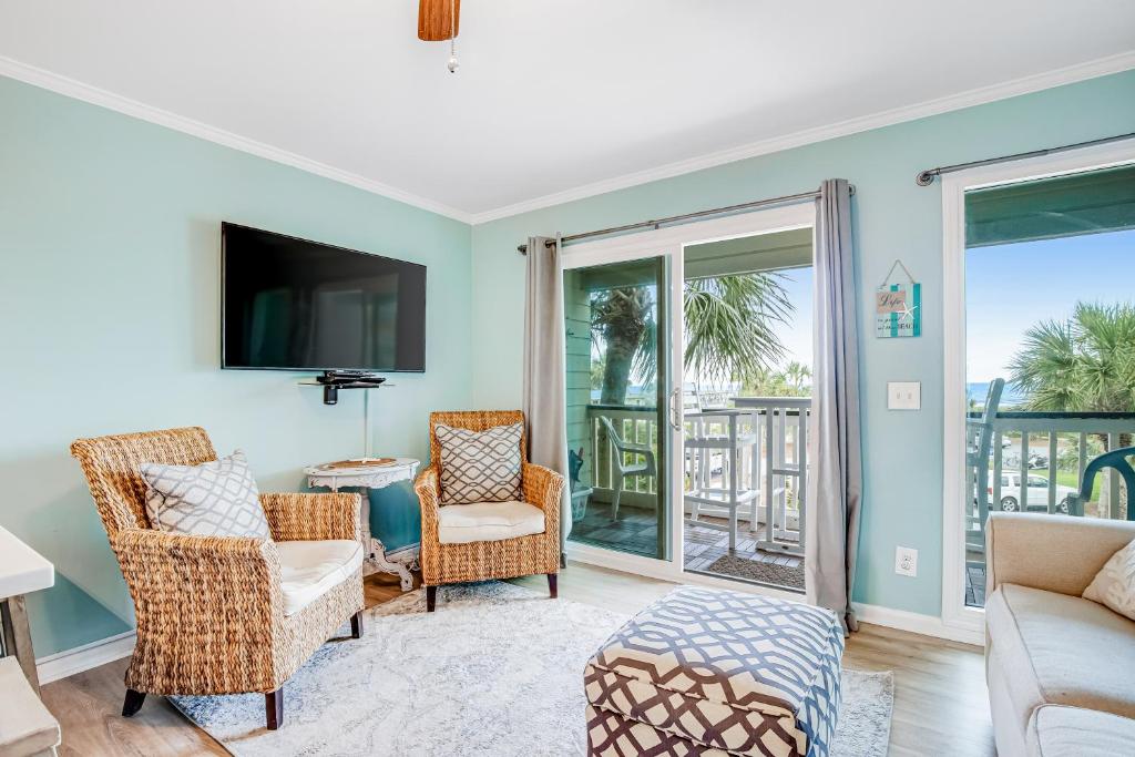 a living room with a couch and chairs and a tv at Seacabin Villa 230-B in Isle of Palms