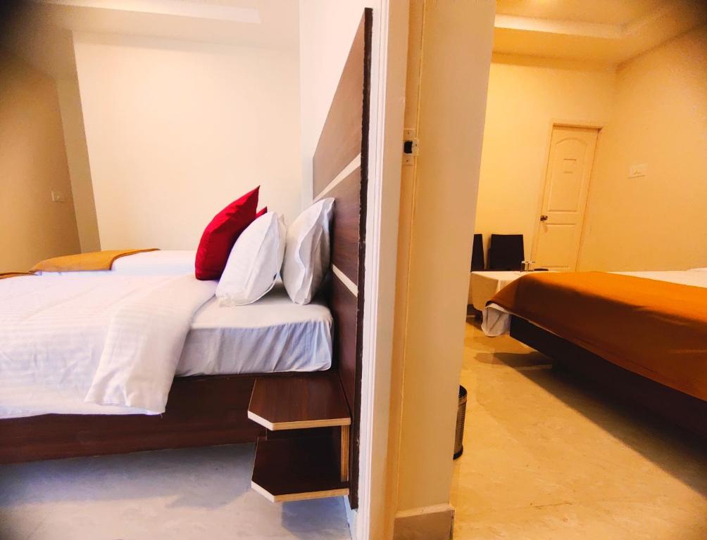 Postel nebo postele na pokoji v ubytování THAAI RESIDENCY