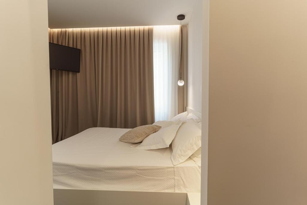 Łóżko lub łóżka w pokoju w obiekcie B&B Nel Blu Dipinto Di Blu
