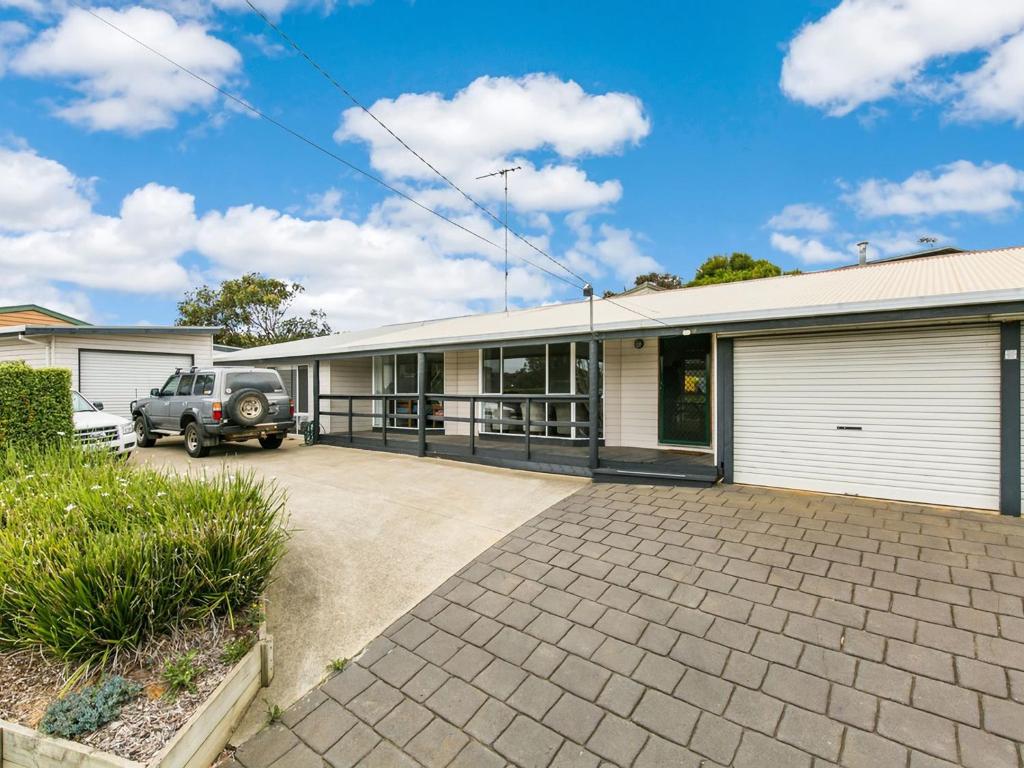 an old car parked in front of a house at Sunset Strip 4 in Torquay