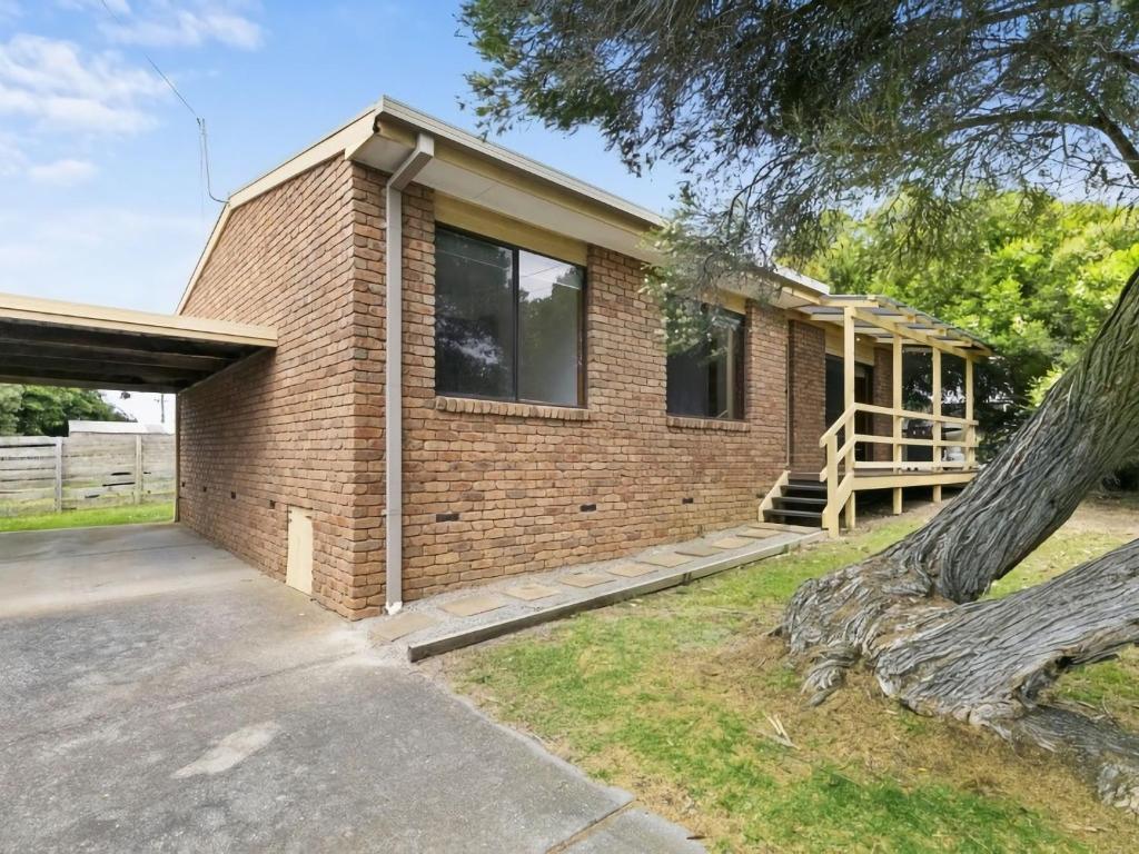 a brick house with a tree in front of it at Muirfield Beach Unit 1-23 in Torquay