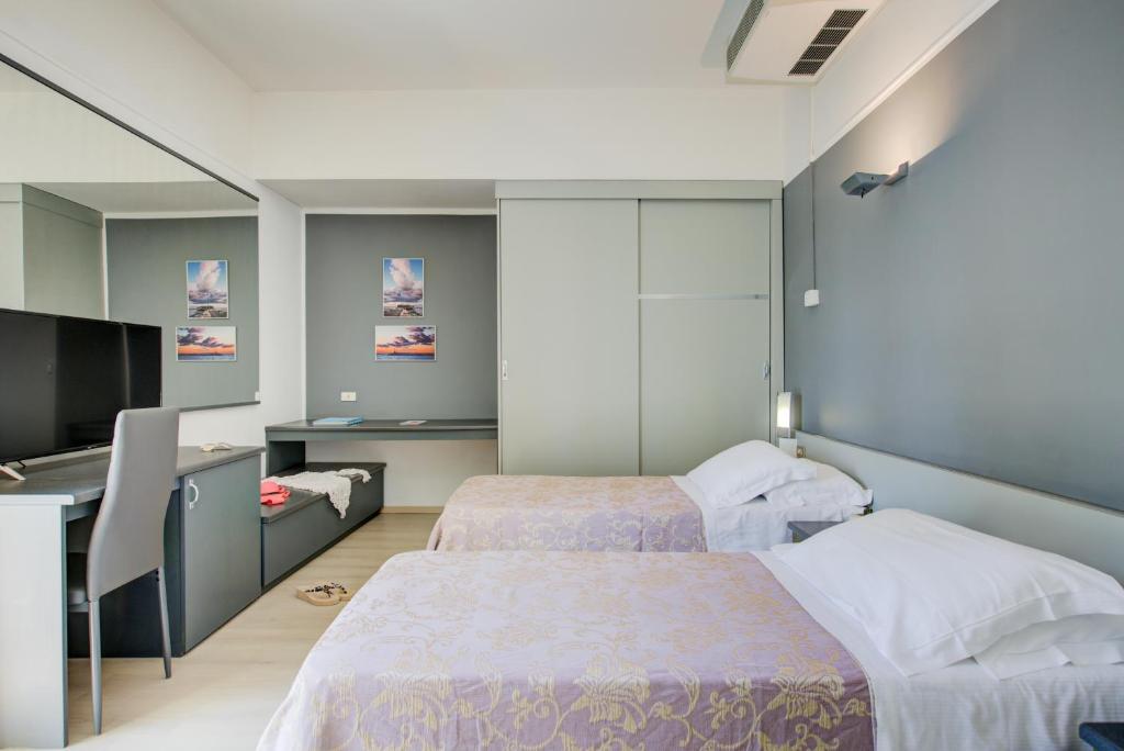 Postel nebo postele na pokoji v ubytování Hotel Ivano