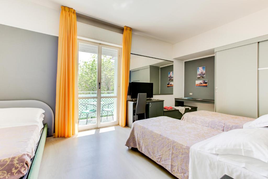 Postel nebo postele na pokoji v ubytování Hotel Ivano