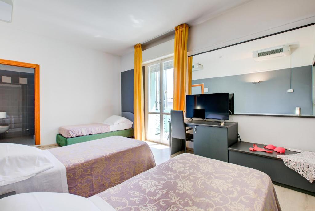 Postel nebo postele na pokoji v ubytování Hotel Ivano