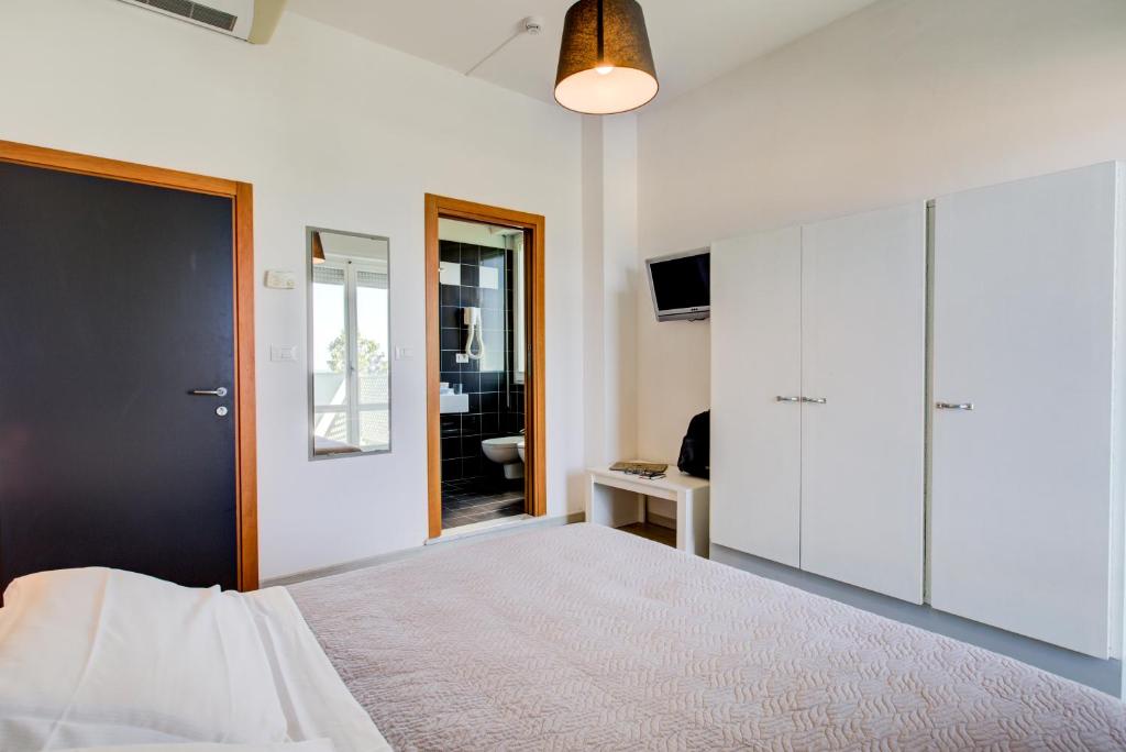 Postel nebo postele na pokoji v ubytování Hotel Ivano