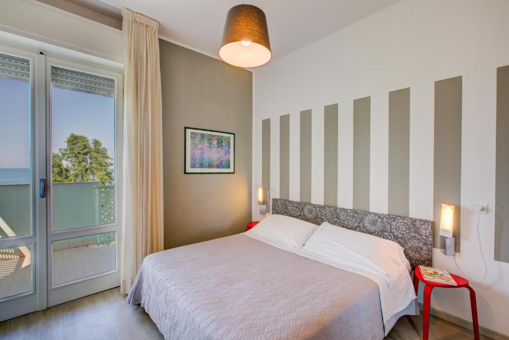Postel nebo postele na pokoji v ubytování Hotel Ivano