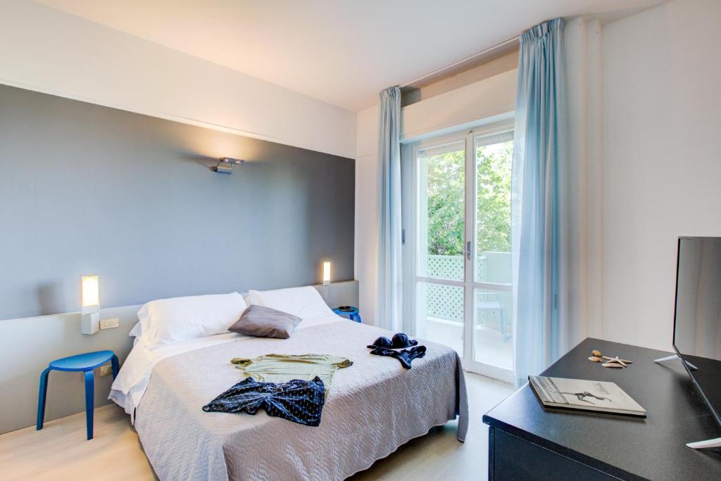 Postel nebo postele na pokoji v ubytování Hotel Ivano