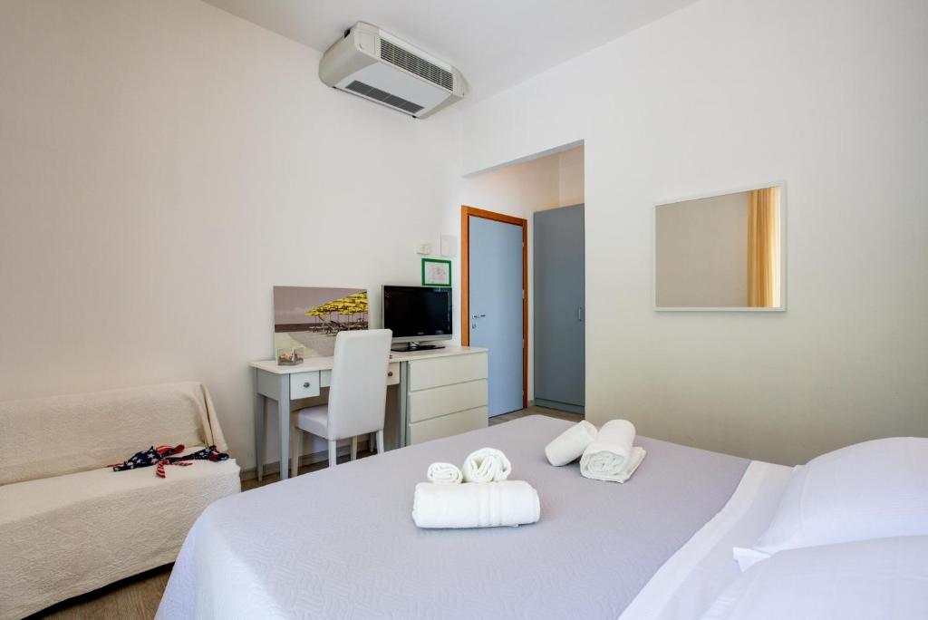 Postel nebo postele na pokoji v ubytování Hotel Ivano