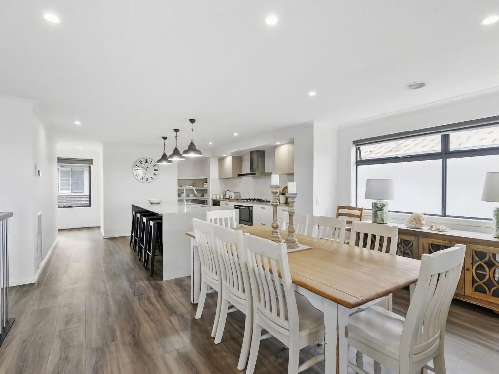 a kitchen and dining room with a table and chairs at Central Beach House 52a in Torquay