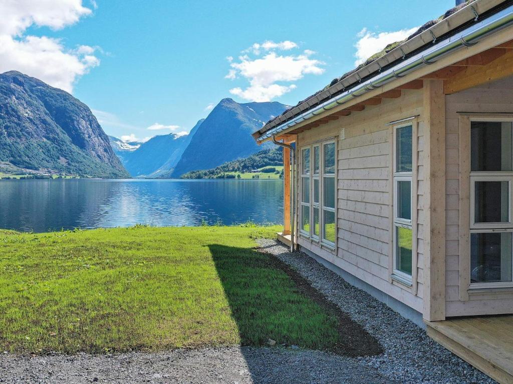 a cabin with a view of a lake and mountains at Holiday home skei i jølster IV in Skei
