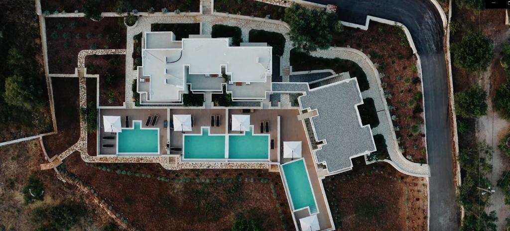 an aerial view of a white building with green at K Villas in Plataria