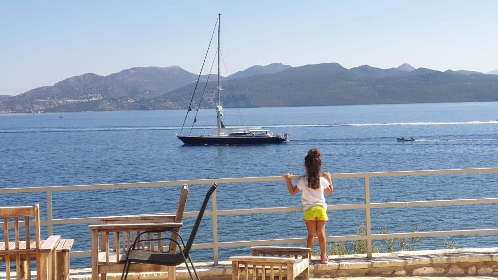 a little girl looking at a sail boat in the water at One Vision in Nikiana