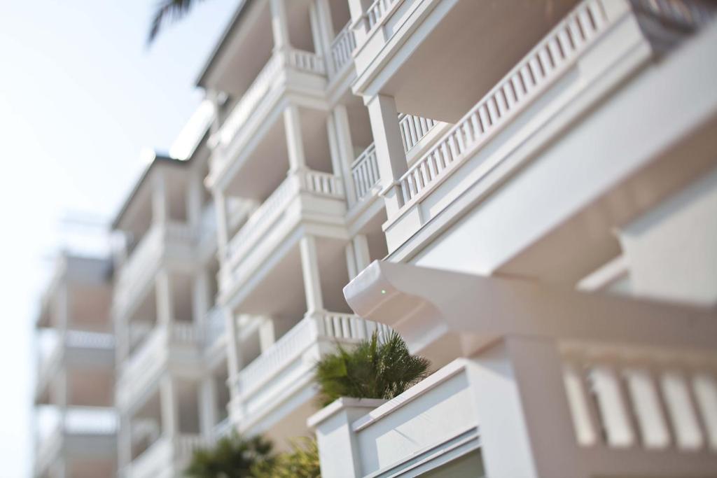 a close up of a building with white balconies at Villa Del Mare Spa Resort in Cervia