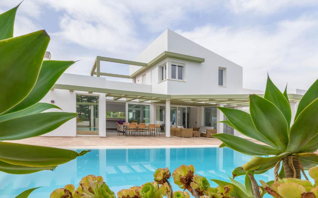 a villa with a swimming pool and a house at Villa Santandria Grupo Seranova Luxury Hotel in Ciutadella
