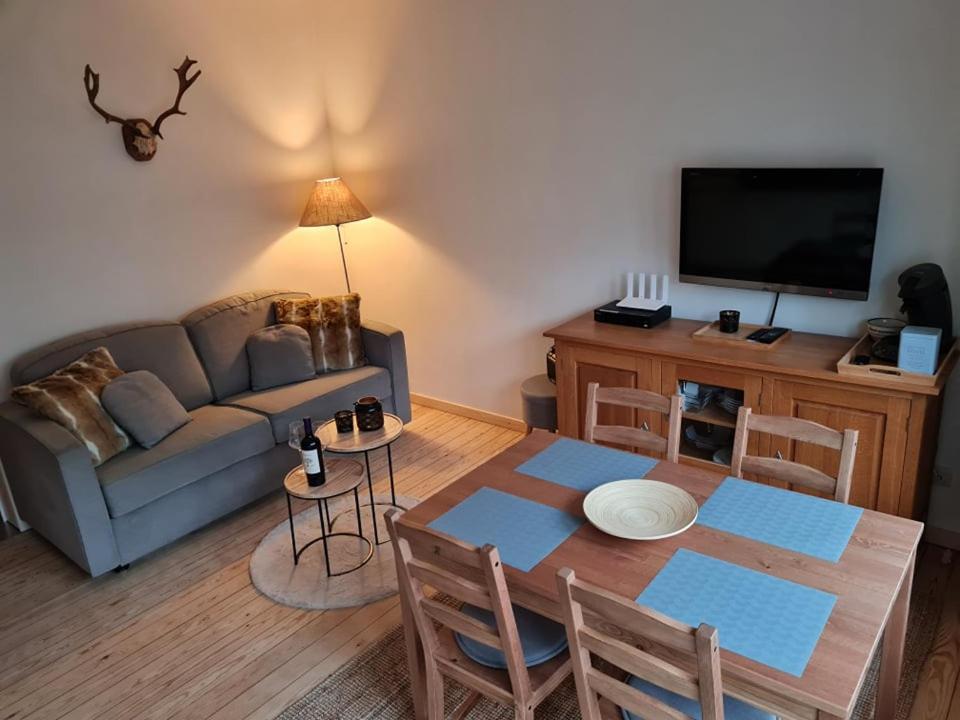a living room with a couch and a table at Alarea in La-Roche-en-Ardenne