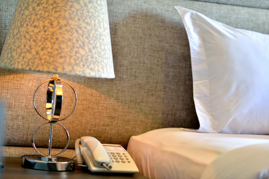 Postel nebo postele na pokoji v ubytování Serela Merdeka by KAGUM Hotels