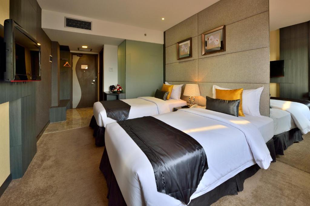 Postel nebo postele na pokoji v ubytování Serela Merdeka by KAGUM Hotels