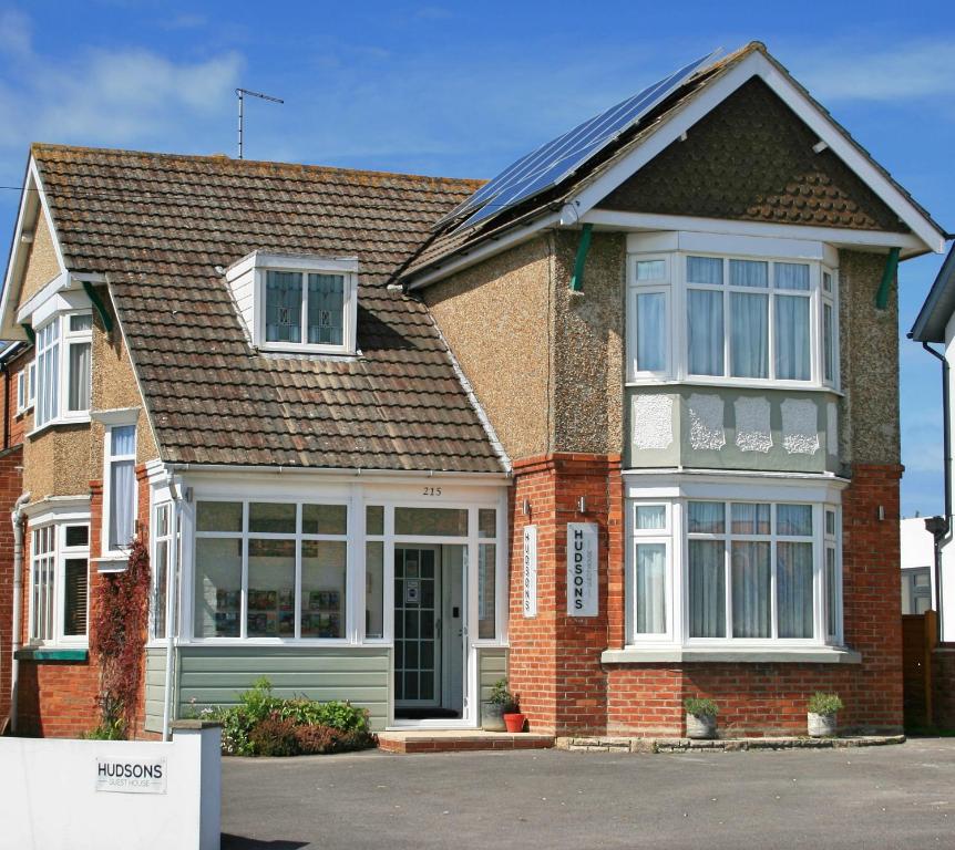 a brick house with a large window at Hudsons Guest House - Adults only in Weymouth