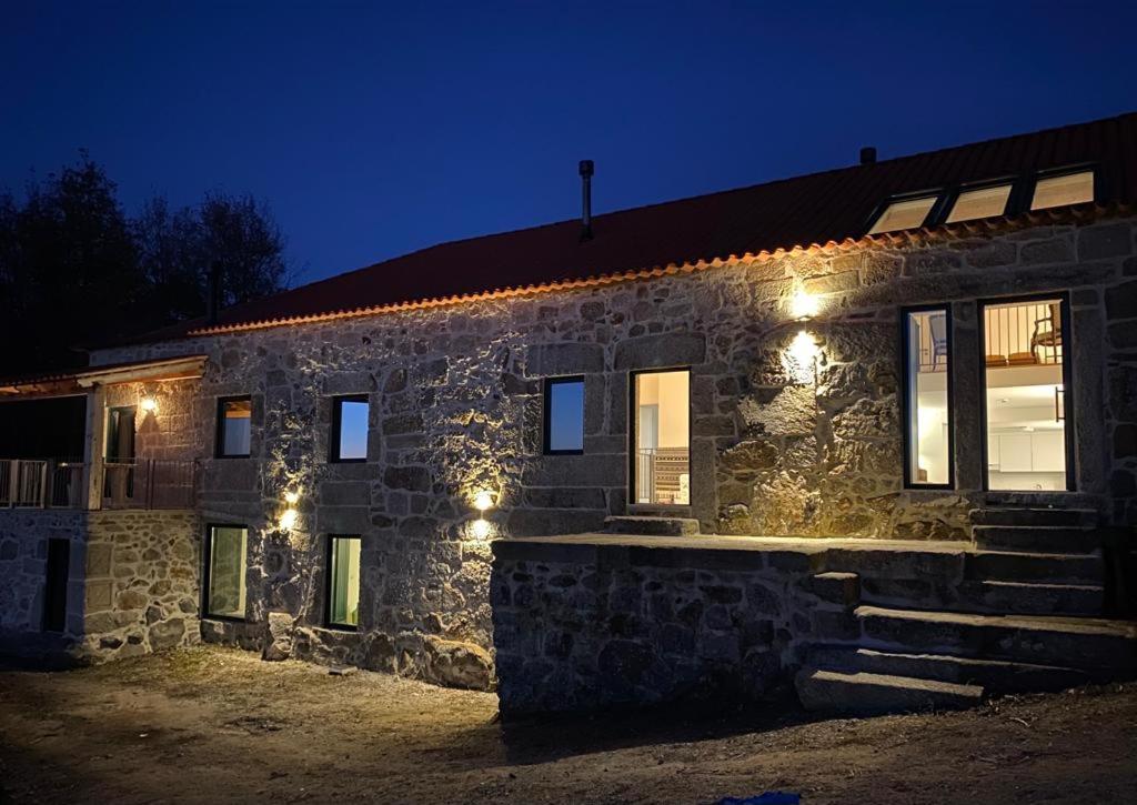 ein Steingebäude mit Lichtern in der Nacht in der Unterkunft Quinta Casa do Retiro in Penalva do Castelo