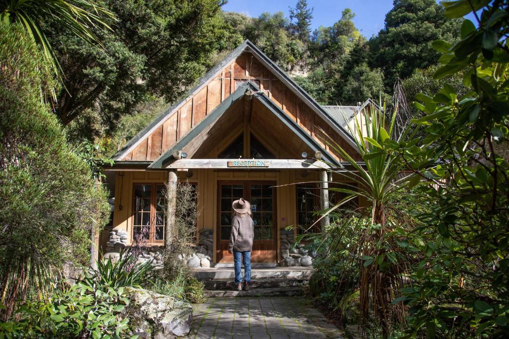 a person standing in front of a house at River Valley Lodge in Taihape