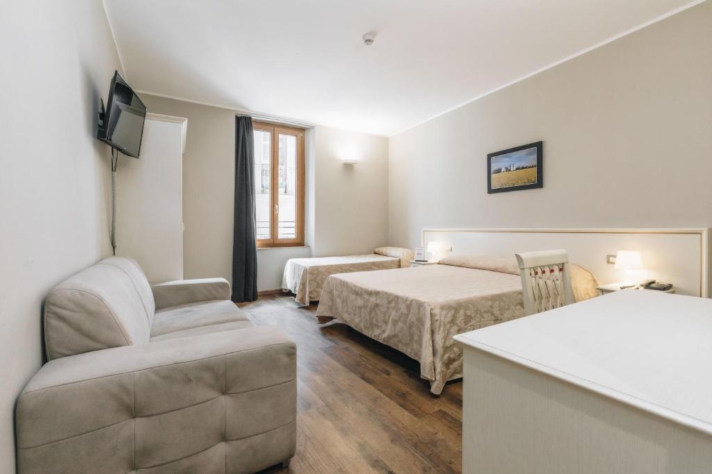 Postel nebo postele na pokoji v ubytování Hotel Astoria