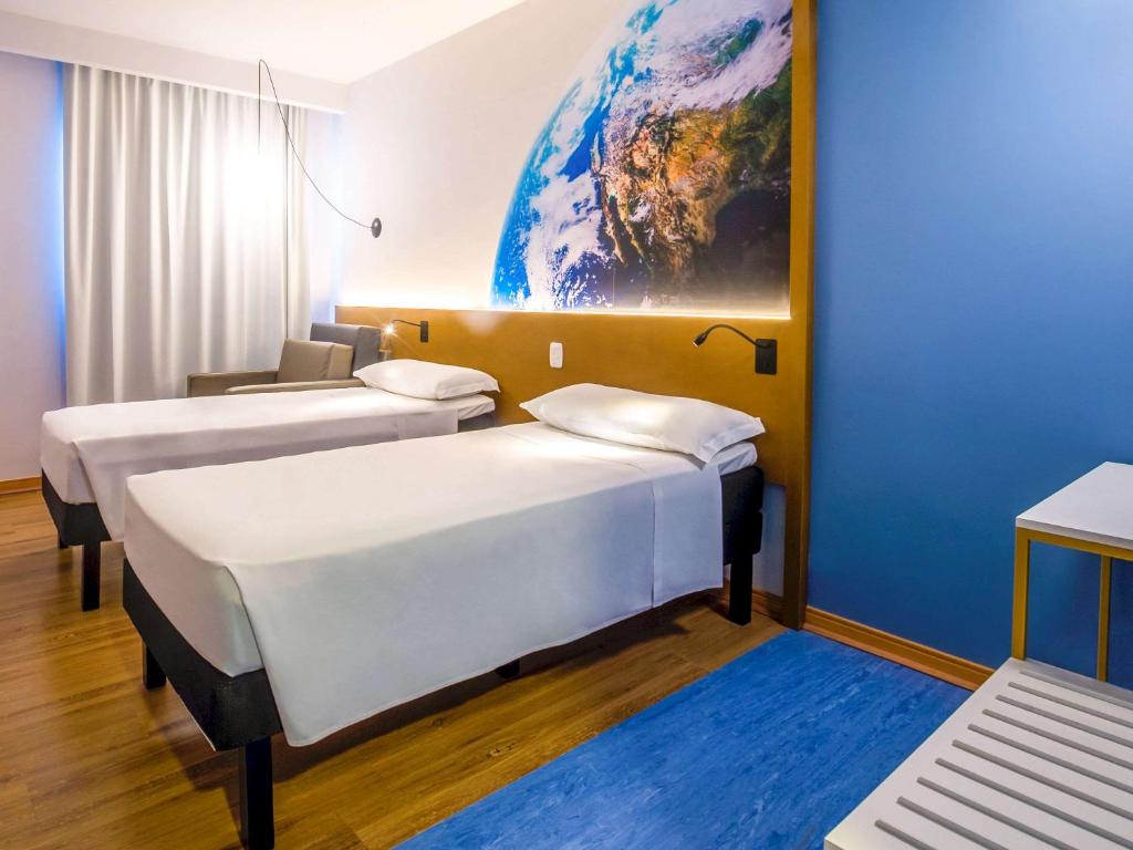 Postel nebo postele na pokoji v ubytování Hotel Euro Suite Curitiba Batel By Nacional Inn