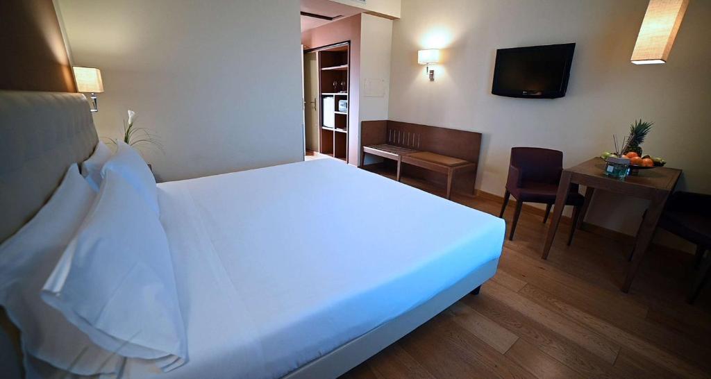 Postel nebo postele na pokoji v ubytování Best Western Grand Hotel Guinigi
