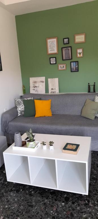 a living room with a couch and a coffee table at Comfortable central apartment in Heraklio
