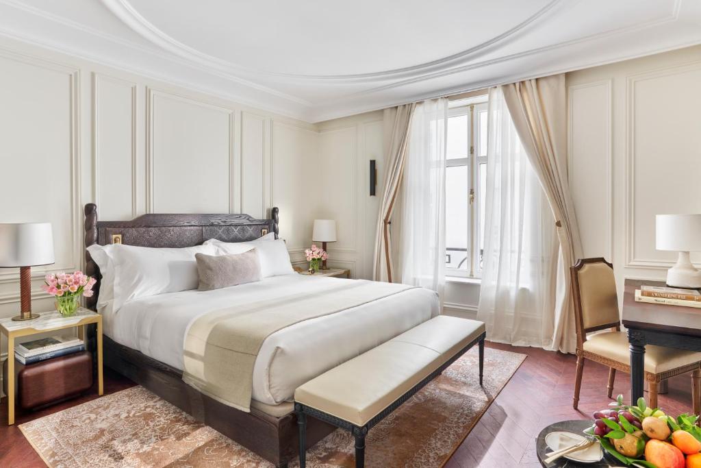 a bedroom with a king sized bed and a table at Mandarin Oriental Ritz, Madrid in Madrid