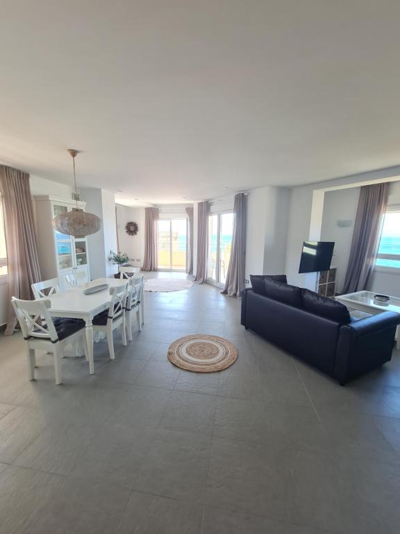 a living room with a couch and a table at Moraira Beach in Moraira