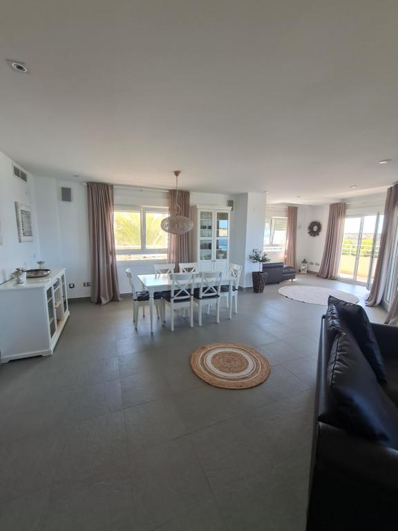 a large living room with a table and chairs at Moraira Beach in Moraira
