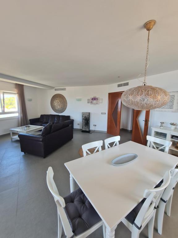 a living room with a white table and chairs at Moraira Beach in Moraira