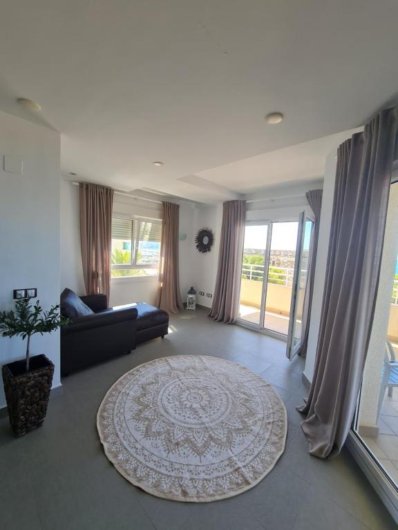 a living room with a couch and a rug at Moraira Beach in Moraira