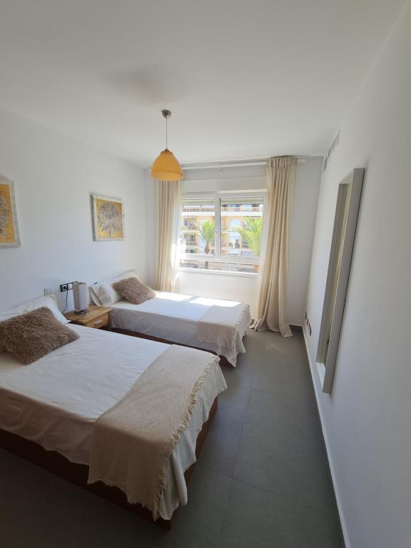 a bedroom with two beds and a window at Moraira Beach in Moraira
