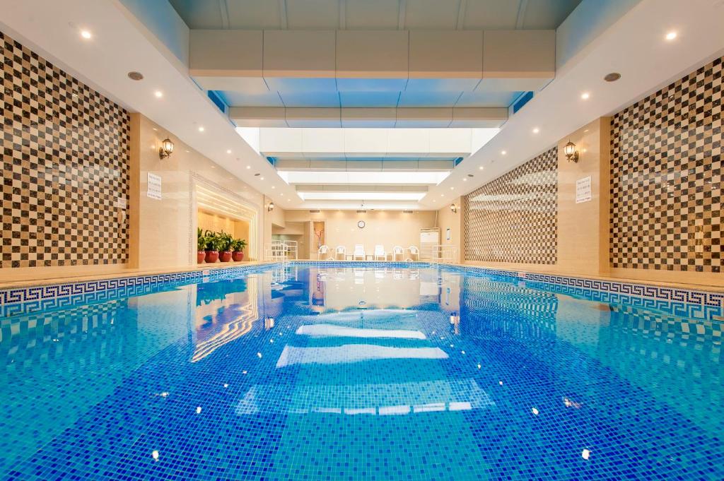 an indoor swimming pool with a large pool at Crowne Plaza Shanghai by IHG in Shanghai