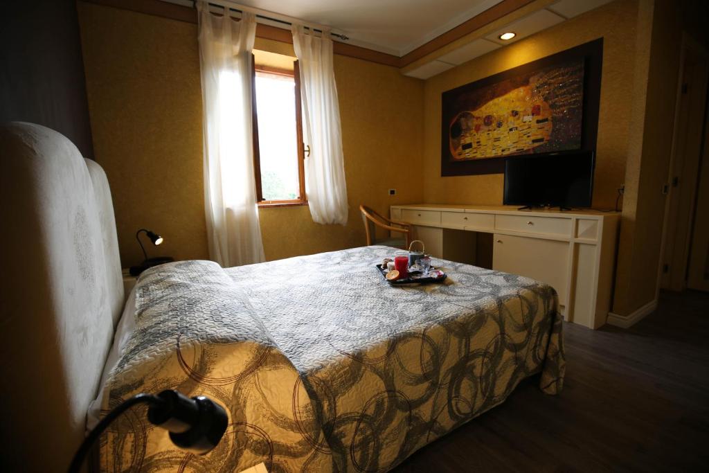 Postel nebo postele na pokoji v ubytování Hotel Benedetti