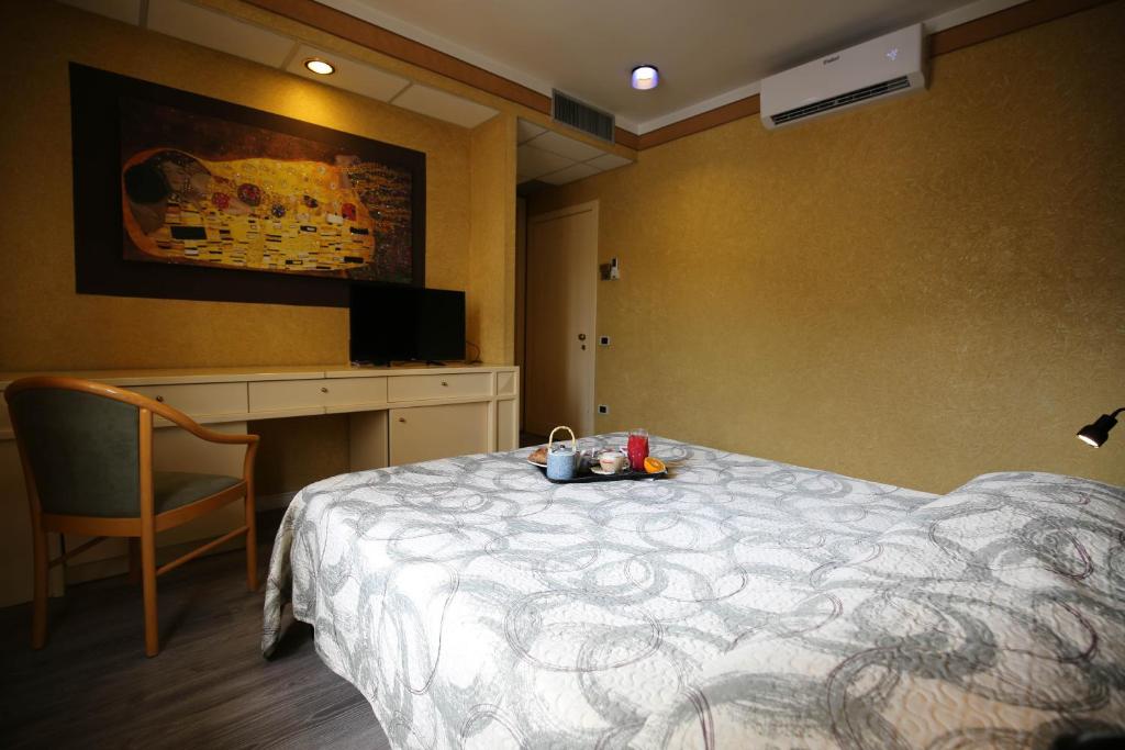 Postel nebo postele na pokoji v ubytování Hotel Benedetti