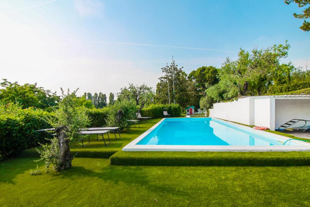 a swimming pool in the yard of a house at Lake & Country Holidays in Bussolengo