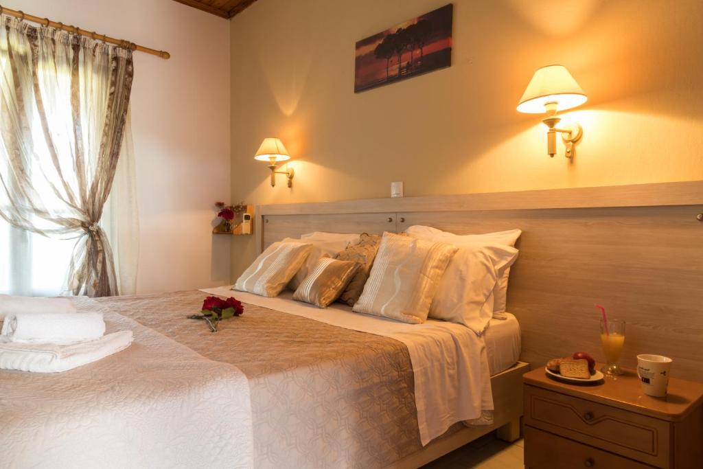 a bedroom with a large bed with flowers on it at Tasia Studios in Perivolion