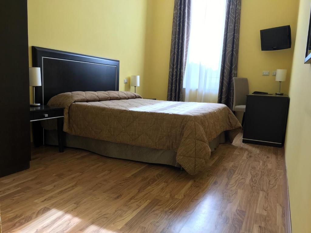 Postel nebo postele na pokoji v ubytování Hotel Villa Cinzia