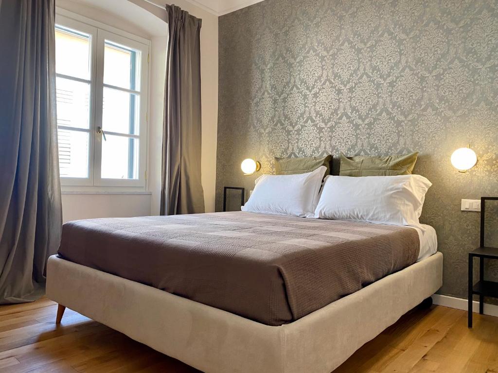 a bedroom with a large bed with a window at Residenza d'epoca dei Fondachi in Sarzana