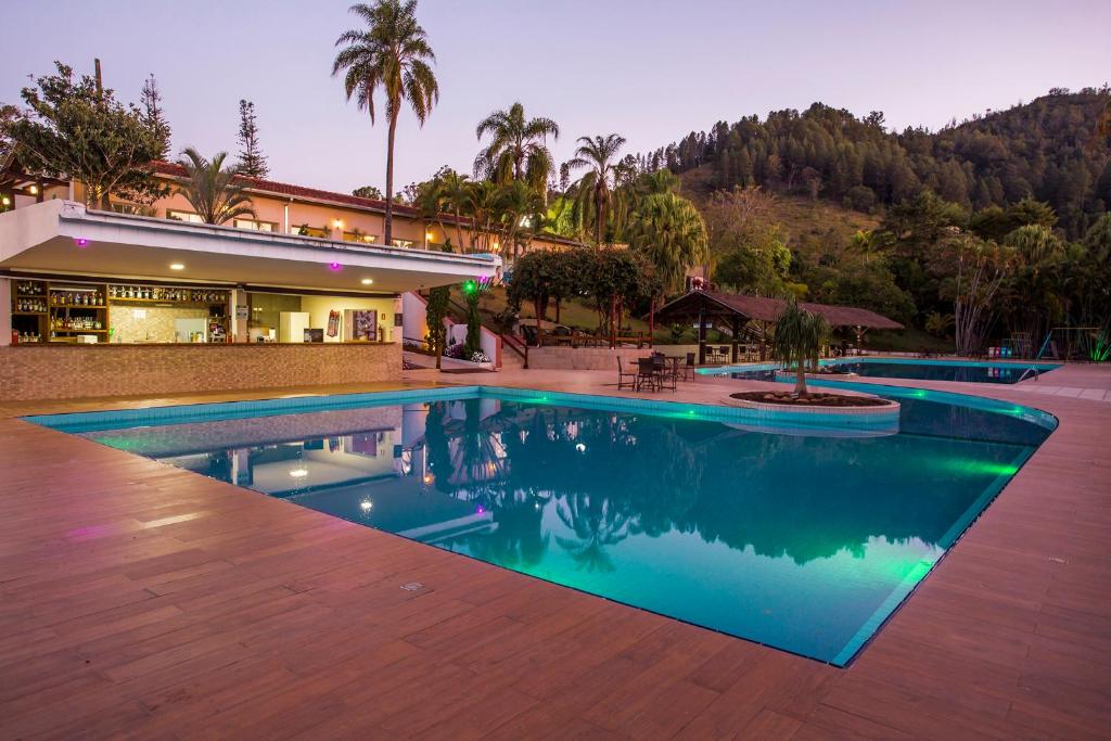 a large swimming pool in front of a building at Guarany Eco Resort in Monte Sião