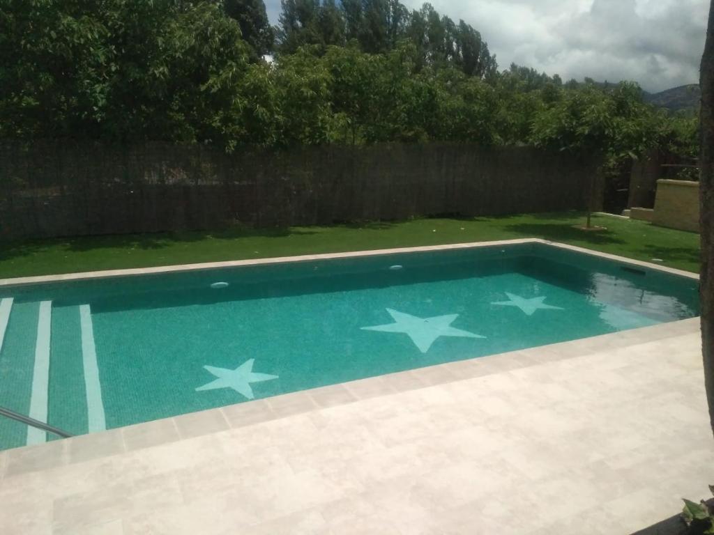 a swimming pool with stars painted on it at Huerta La Laja,Casa Grande in Ronda