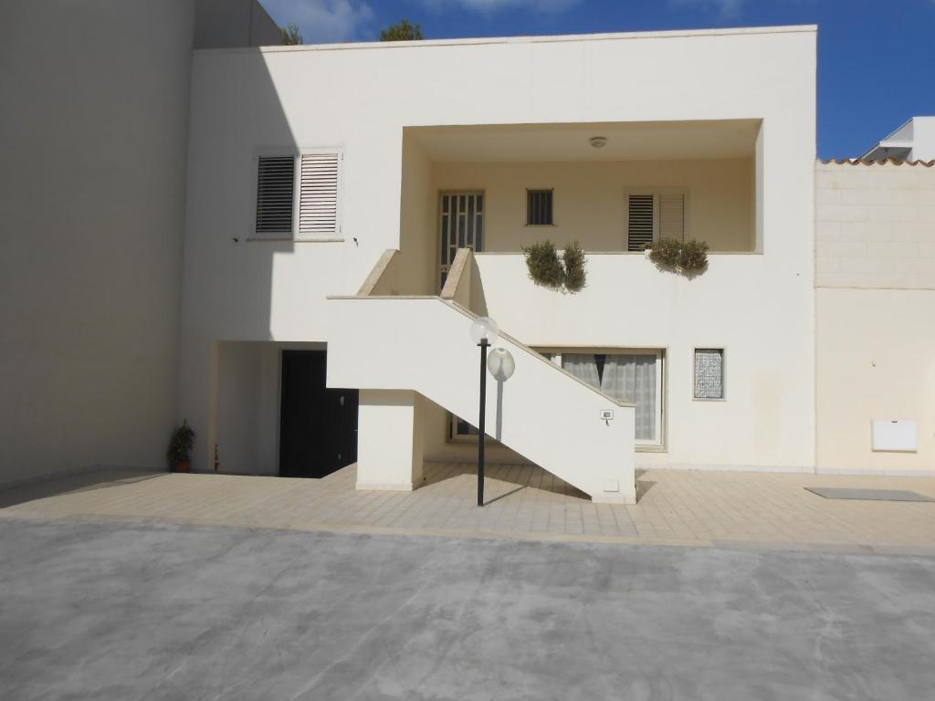 a white house with a staircase in front of it at Casa Raffaele in Leuca