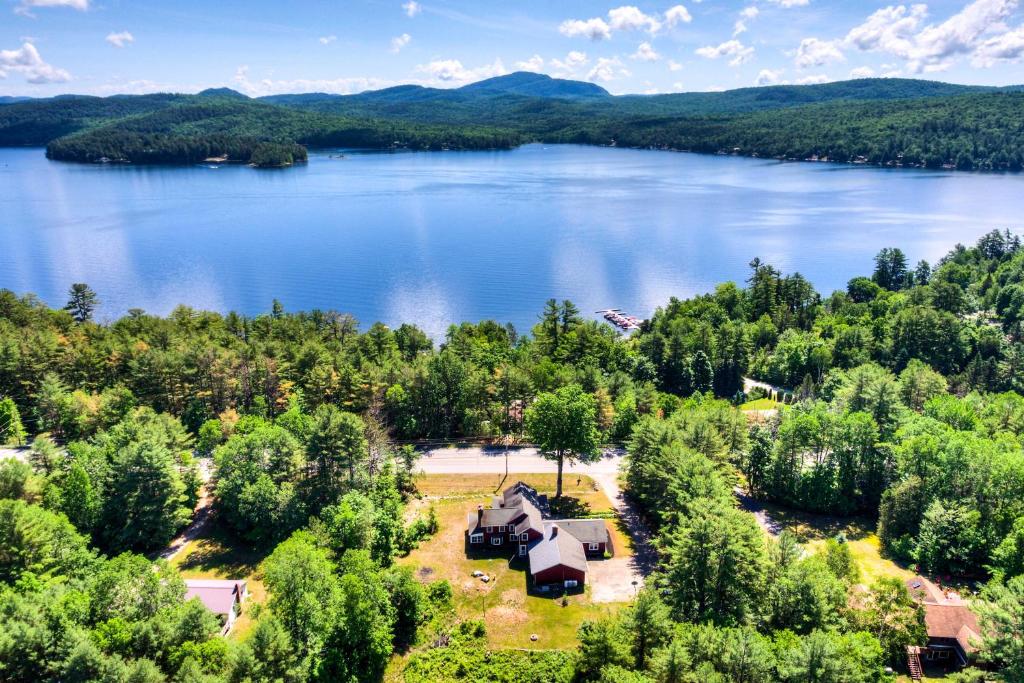 an aerial view of a lake with a house at Vintage Schroon Lake Farmhouse w/ Private Beach! in Schroon Lake