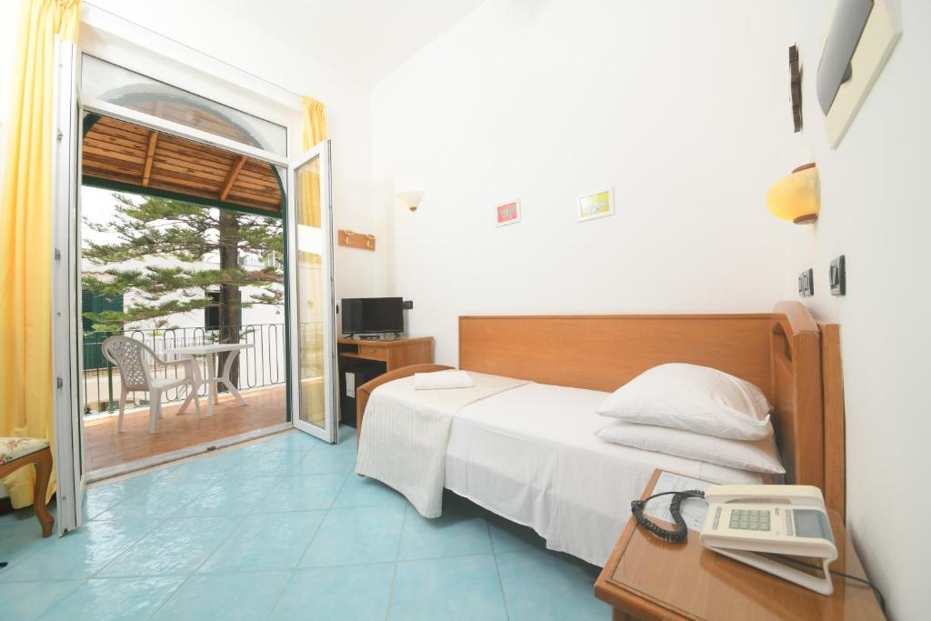 Postel nebo postele na pokoji v ubytování Hotel Pineta